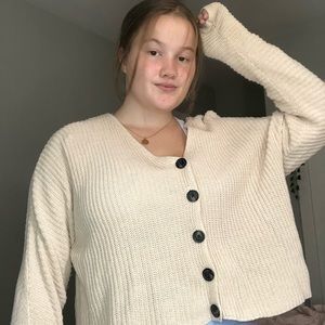 Cute light pink sweater.